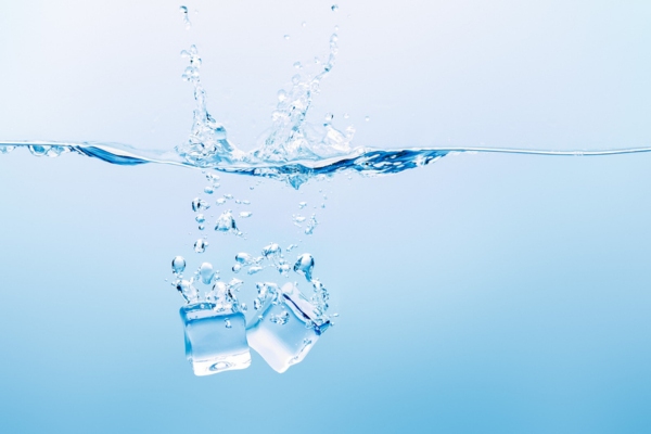 water splash with a couple of ice cubes depicting cycling back of cooled water in the boiler